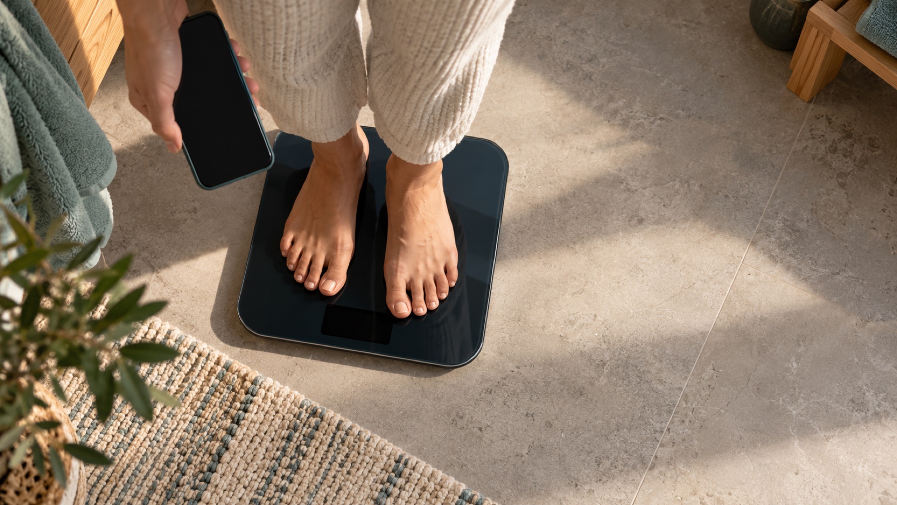 Person recording their weight during a quiet morning routine